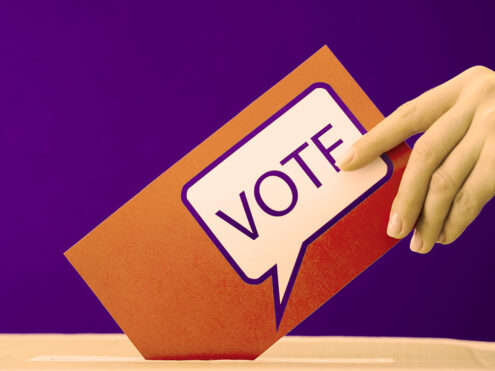 woman-placing-her-ballot-in-the-election-box
